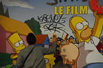 Krevet finishing off his tag on Simpson movie poster in the Metro.